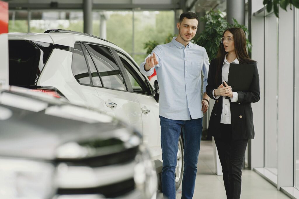 dealership employee selling car to client